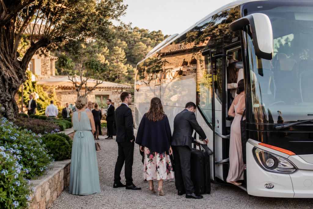 Alquiler de autobuses para bodas en Barcelona con autobús de lujo y chófer profesional frente a un elegante lugar de celebración